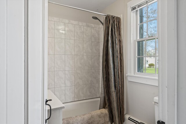 full bath featuring baseboard heating, shower / bath combo with shower curtain, toilet, and a healthy amount of sunlight