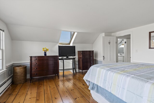 bedroom featuring wood-type flooring, a baseboard radiator, and lofted ceiling with skylight