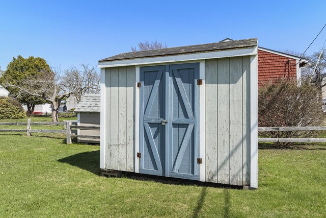 view of shed featuring fence