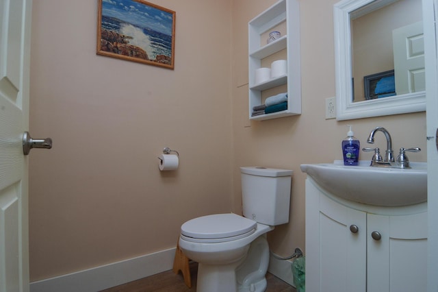 6A Park St, Guilford, ME 04443 - half bathroom with toilet, wood finished floors, vanity, and baseboards