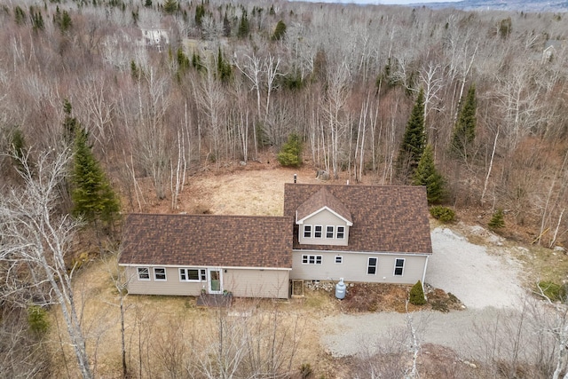 drone / aerial view featuring a wooded view