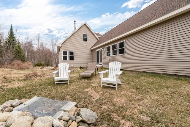 rear view of property with a lawn
