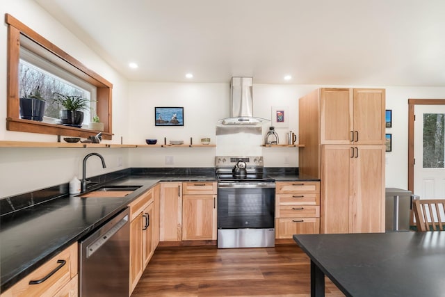 kitchen featuring light brown cabinetry, stainless steel appliances, open shelves, wall chimney range hood, and a sink