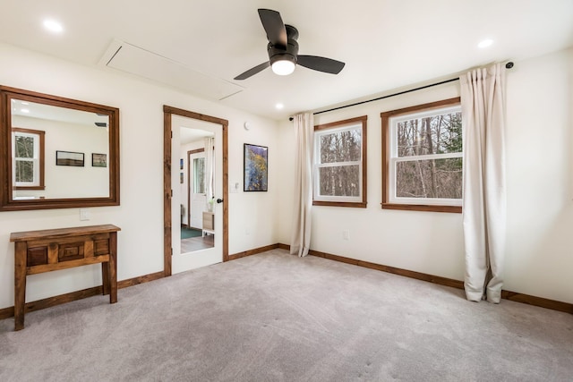 unfurnished bedroom featuring attic access, baseboards, carpet flooring, and recessed lighting