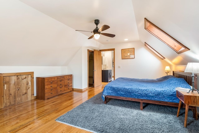 bedroom with vaulted ceiling, a ceiling fan, and wood finished floors