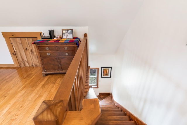 stairs featuring wood finished floors