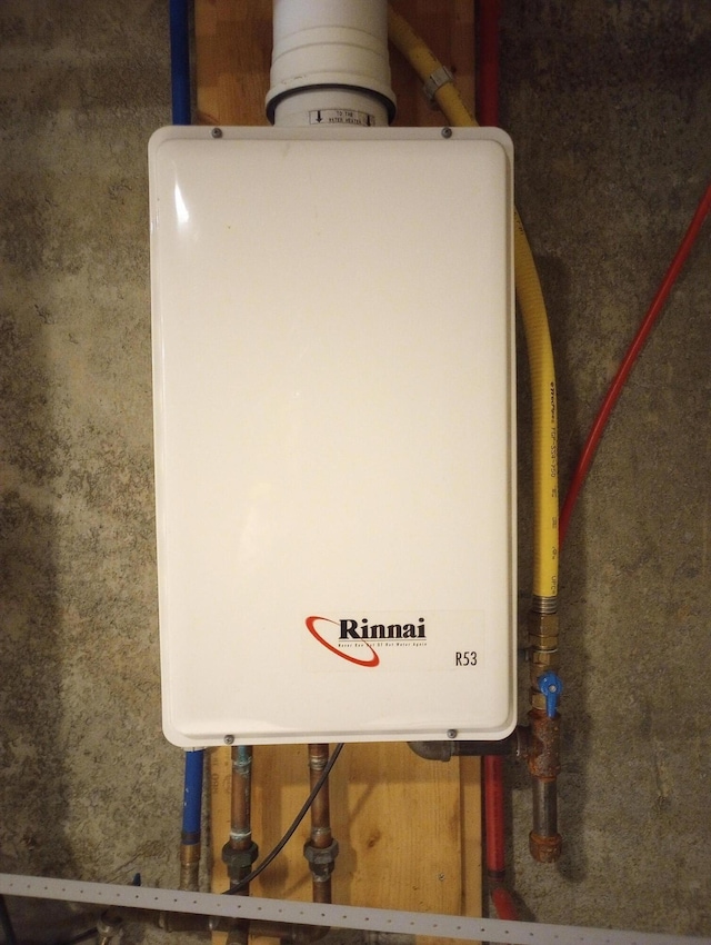utility room featuring water heater