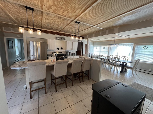 475 Main St, Van Buren, ME 04785 - dining space with wooden ceiling, light tile patterned floors, and a baseboard radiator