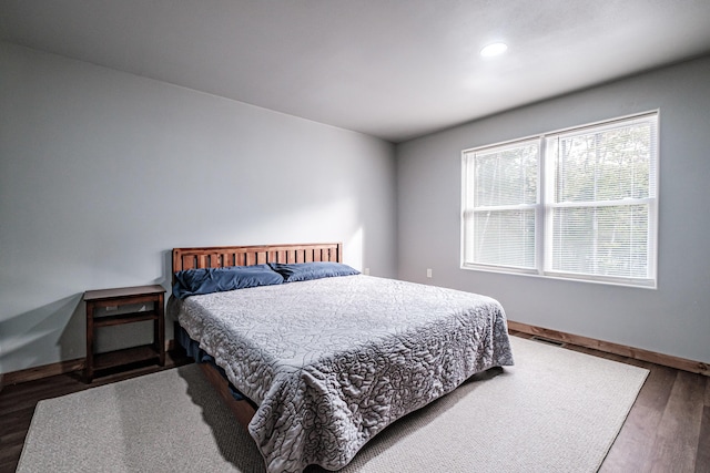 bedroom with wood finished floors, baseboards, visible vents, and recessed lighting