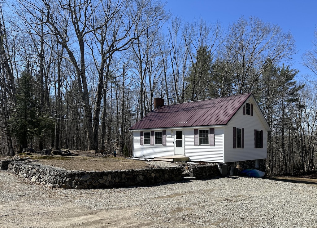 2586 Acton Ridge Rd, Newfield, ME 04095 - view of front facade with metal roof and a chimney