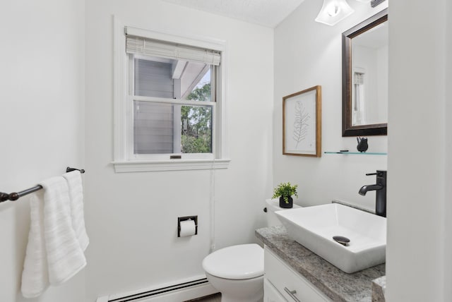 half bath featuring a baseboard radiator, toilet, and vanity