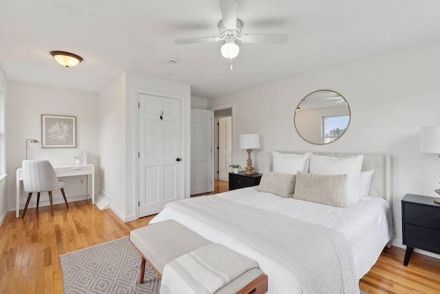 bedroom featuring light wood-style flooring, a ceiling fan, and baseboards
