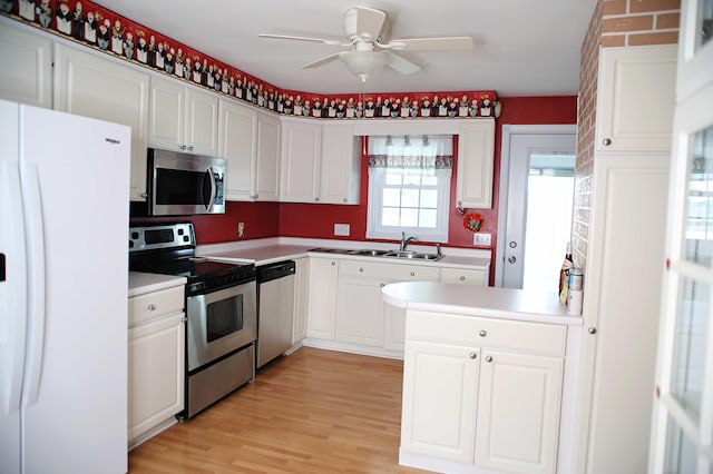 165 Pleasant Ave, Madawaska, ME 04756 - kitchen featuring appliances with stainless steel finishes, a ceiling fan, white cabinetry, a sink, and light wood-type flooring