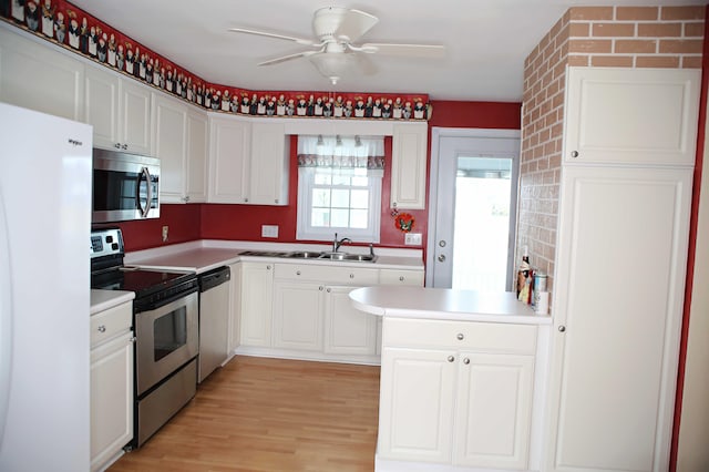 165 Pleasant Ave, Madawaska, ME 04756 - kitchen with appliances with stainless steel finishes, a ceiling fan, and white cabinets