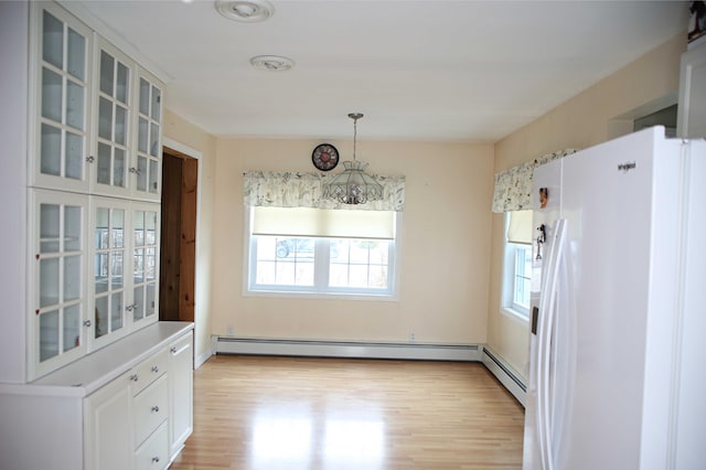 165 Pleasant Ave, Madawaska, ME 04756 - unfurnished dining area with plenty of natural light, light wood finished floors, a baseboard heating unit, and a chandelier