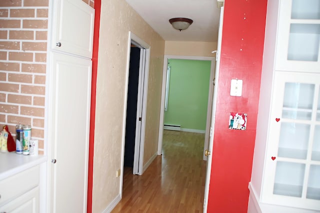 165 Pleasant Ave, Madawaska, ME 04756 - corridor featuring a baseboard heating unit and light wood finished floors