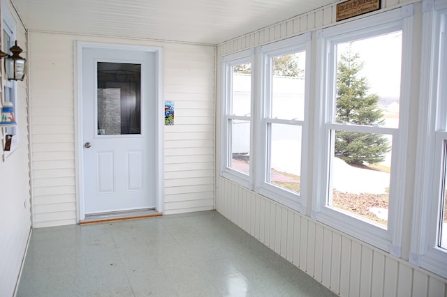 165 Pleasant Ave, Madawaska, ME 04756 - unfurnished sunroom with tile patterned floors, plenty of natural light, and wooden walls