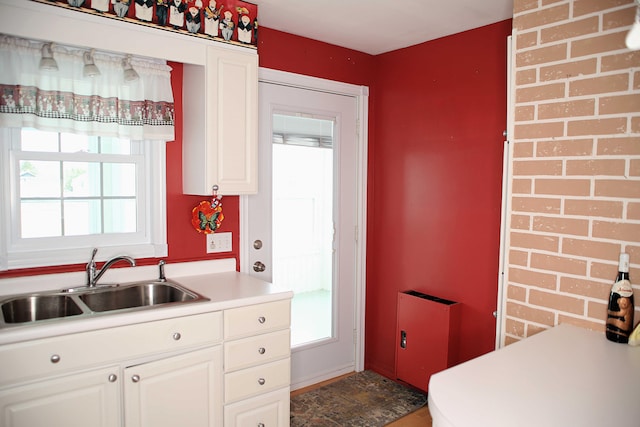 165 Pleasant Ave, Madawaska, ME 04756 - kitchen featuring a sink, plenty of natural light, white cabinets, and light countertops