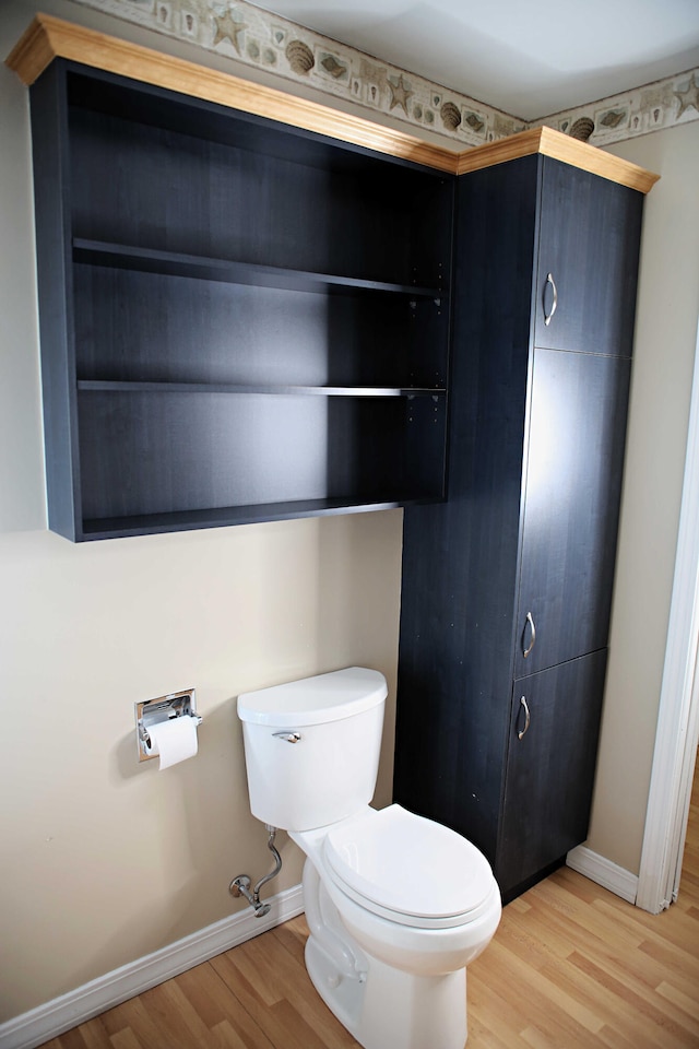165 Pleasant Ave, Madawaska, ME 04756 - bathroom with wood finished floors, toilet, and baseboards