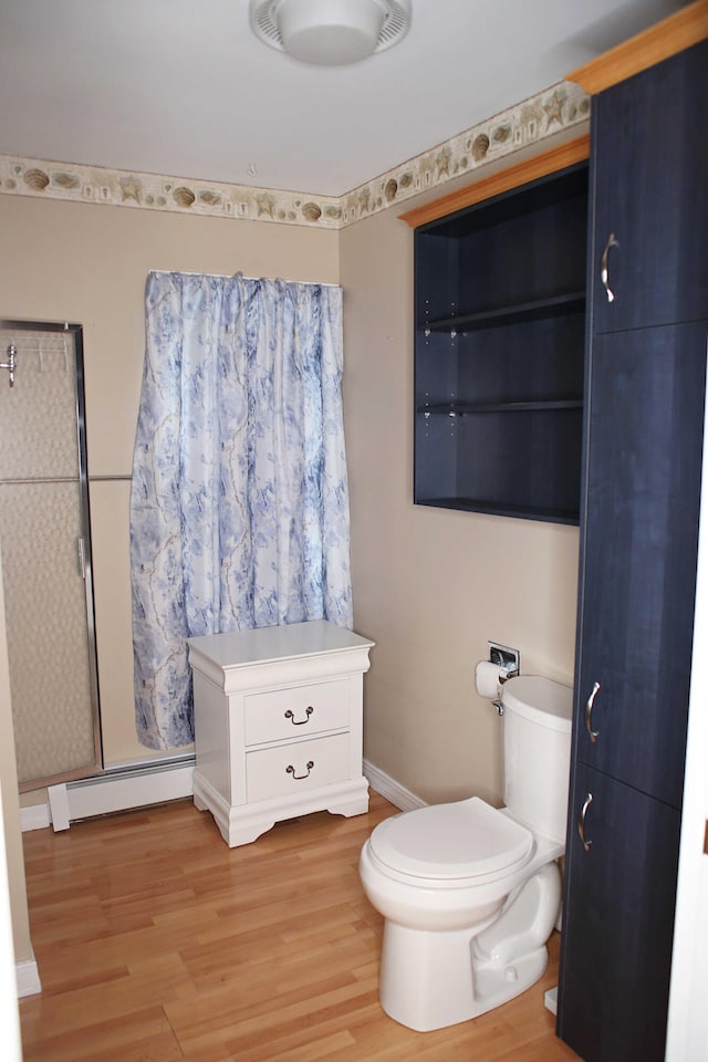 165 Pleasant Ave, Madawaska, ME 04756 - full bath featuring a baseboard radiator, wood finished floors, toilet, a shower stall, and baseboards