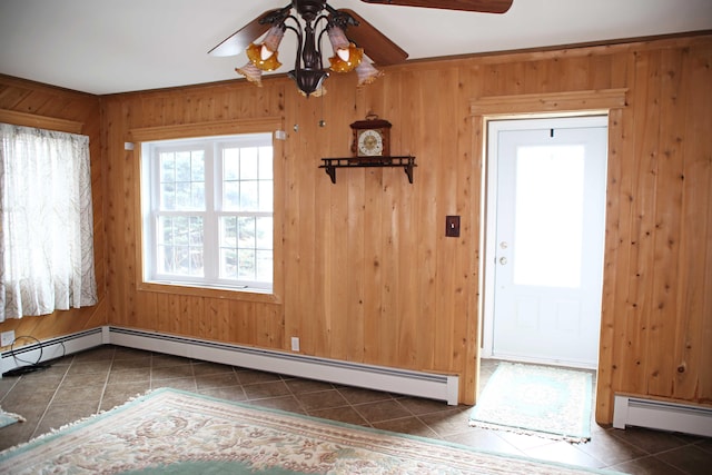 165 Pleasant Ave, Madawaska, ME 04756 - unfurnished dining area featuring a ceiling fan, tile patterned flooring, a baseboard radiator, and wood walls