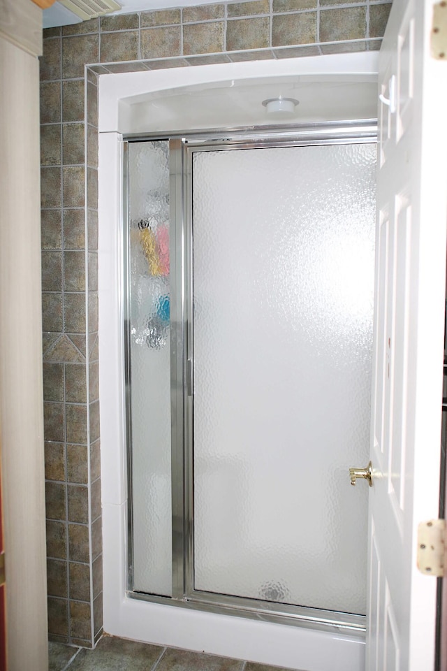 165 Pleasant Ave, Madawaska, ME 04756 - bathroom with a stall shower and tile patterned floors