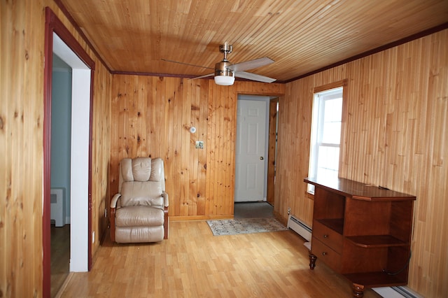 165 Pleasant Ave, Madawaska, ME 04756 - unfurnished room with a baseboard heating unit, a ceiling fan, light wood-type flooring, wood walls, and wooden ceiling