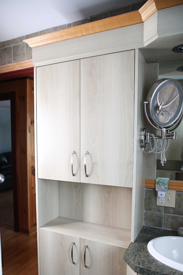 165 Pleasant Ave, Madawaska, ME 04756 - detailed view of a sink, wood finished floors, and backsplash