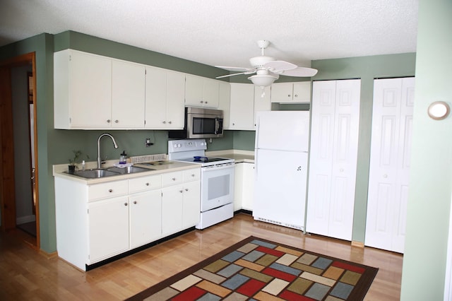 165 Pleasant Ave, Madawaska, ME 04756 - kitchen with white appliances, a sink, ceiling fan, light wood-type flooring, and white cabinetry