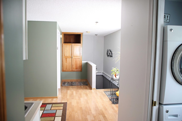 165 Pleasant Ave, Madawaska, ME 04756 - laundry area featuring light wood-type flooring, estacked washer and dryer, and baseboards