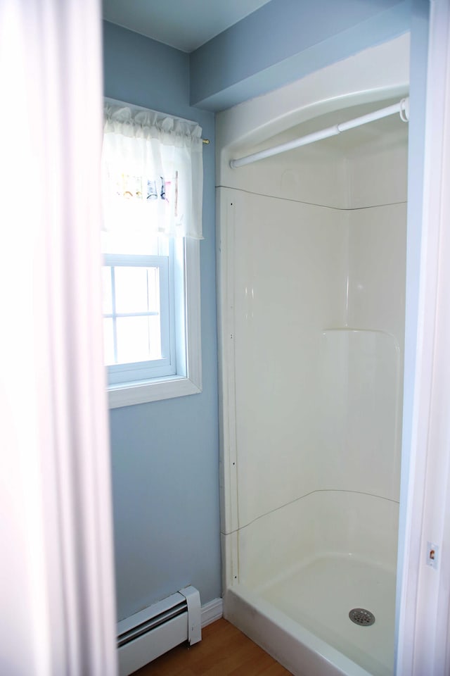 165 Pleasant Ave, Madawaska, ME 04756 - bathroom featuring a baseboard radiator, a stall shower, and wood finished floors