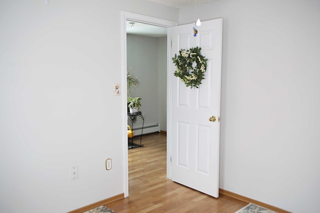 165 Pleasant Ave, Madawaska, ME 04756 - unfurnished room with a baseboard radiator, light wood-style floors, and baseboards