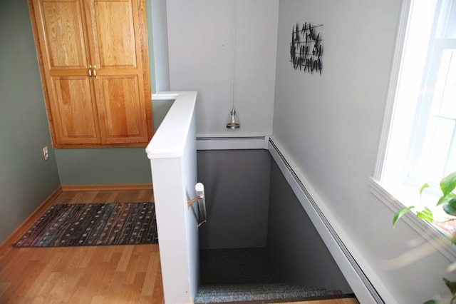 165 Pleasant Ave, Madawaska, ME 04756 - stairway featuring baseboard heating and wood finished floors
