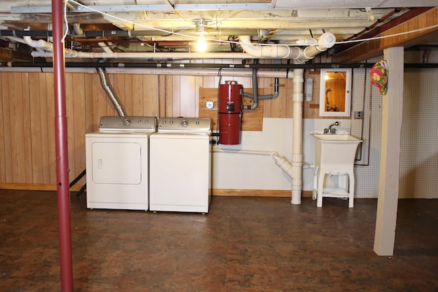 165 Pleasant Ave, Madawaska, ME 04756 - unfinished basement with washer and clothes dryer, a central vacuum unit, baseboards, wooden walls, and a sink
