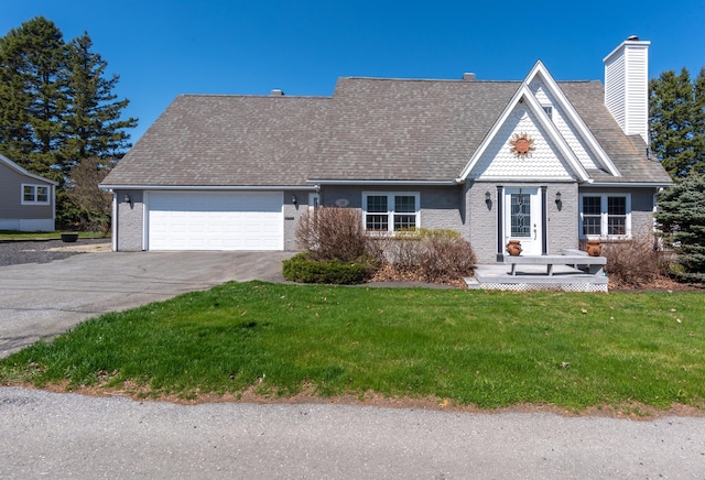 165 Pleasant Ave, Madawaska, ME 04756 - view of front of house with a garage, driveway, a chimney, a front yard, and brick siding