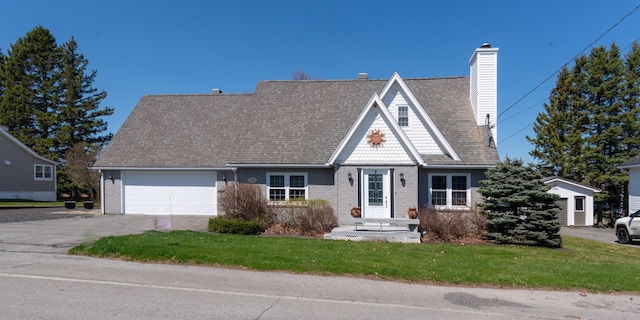 165 Pleasant Ave, Madawaska, ME 04756 - view of front of house with a garage, concrete driveway, a front yard, and brick siding