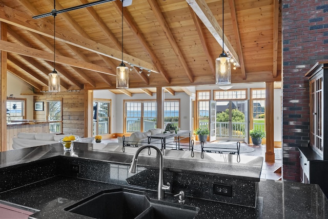 kitchen featuring wooden ceiling and open floor plan