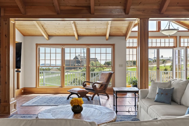 sunroom / solarium featuring beam ceiling