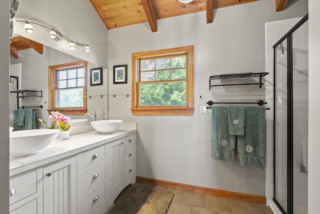 bathroom with a sink, wooden ceiling, lofted ceiling with beams, and a shower stall