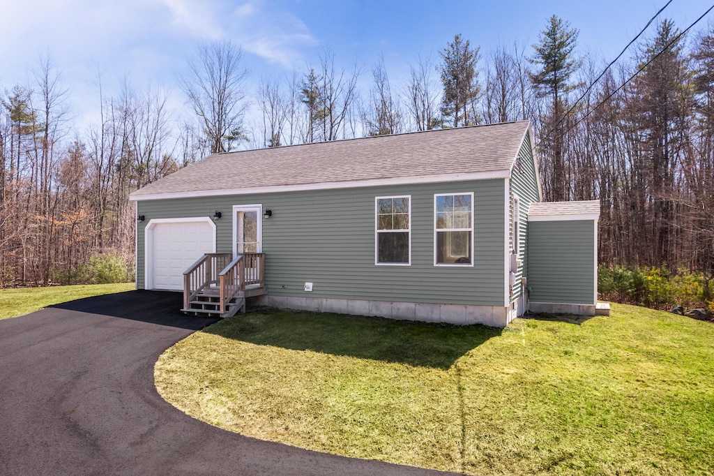 734 River Rd, Eliot, ME 03903 - manufactured / mobile home with roof with shingles, aphalt driveway, a garage, and a front yard