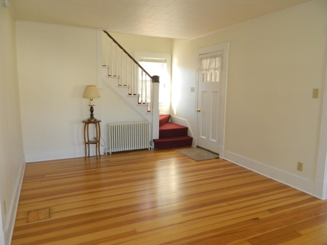 1 Prospect St, Sanford, ME 04083 - entryway with stairway, light wood-style floors, baseboards, and radiator