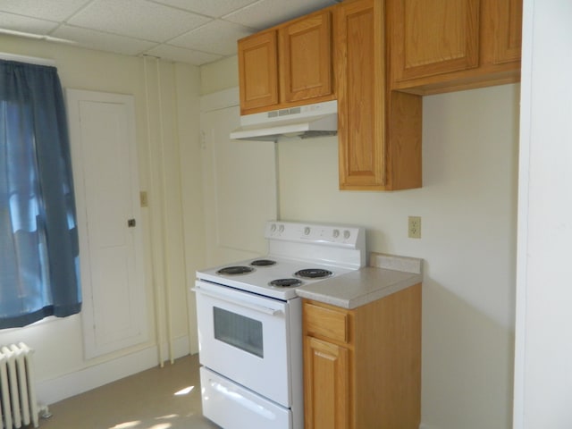 1 Prospect St, Sanford, ME 04083 - kitchen featuring light countertops, under cabinet range hood, white electric range, radiator, and a drop ceiling
