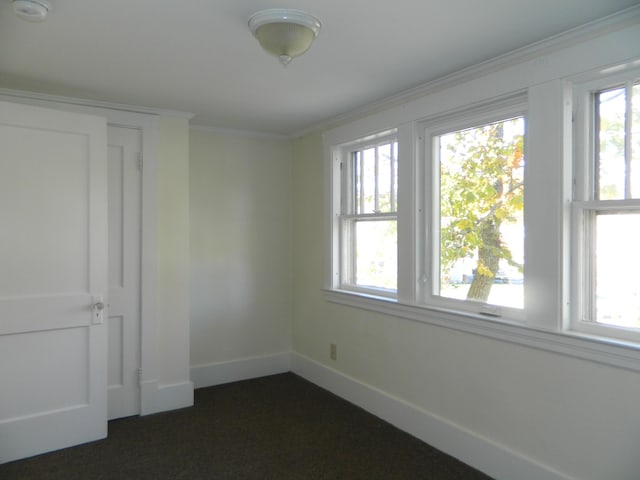 1 Prospect St, Sanford, ME 04083 - empty room with plenty of natural light, baseboards, and ornamental molding