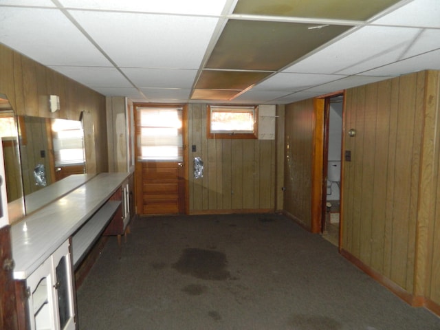 1 Prospect St, Sanford, ME 04083 - below grade area with wood walls, a drop ceiling, and carpet