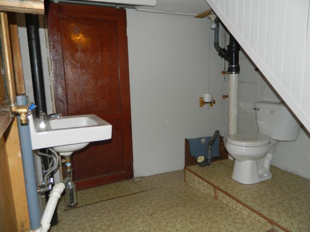 1 Prospect St, Sanford, ME 04083 - half bath featuring toilet, tile patterned floors, and a sink