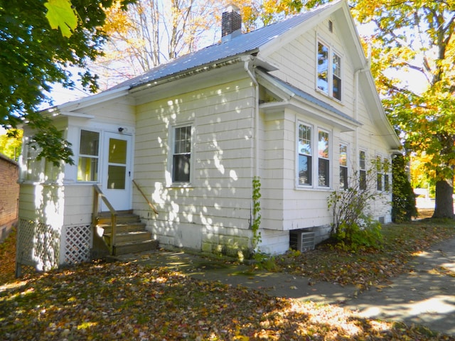 1 Prospect St, Sanford, ME 04083 - view of front facade featuring entry steps, metal roof, and a chimney