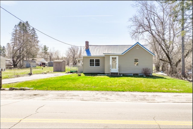 21 Exeter Rd, Corinna, ME 04928 - single story home featuring a chimney, entry steps, a front yard, and metal roof