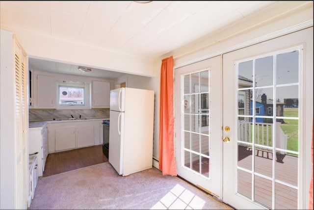 21 Exeter Rd, Corinna, ME 04928 - kitchen featuring a sink, stove, french doors, freestanding refrigerator, and light colored carpet