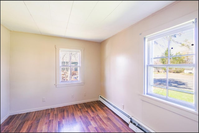 21 Exeter Rd, Corinna, ME 04928 - spare room featuring dark wood-type flooring, baseboards, and a healthy amount of sunlight