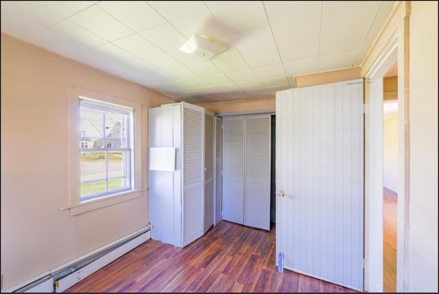 21 Exeter Rd, Corinna, ME 04928 - unfurnished bedroom featuring a closet, baseboard heating, and wood finished floors